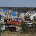 Blue tarps cover several rooftops Monday as crews work to salvage and clean up tornado-damaged homes in the Huron Farms subdivision in Dexter. Melanie Maxwell I AnnArbor.com